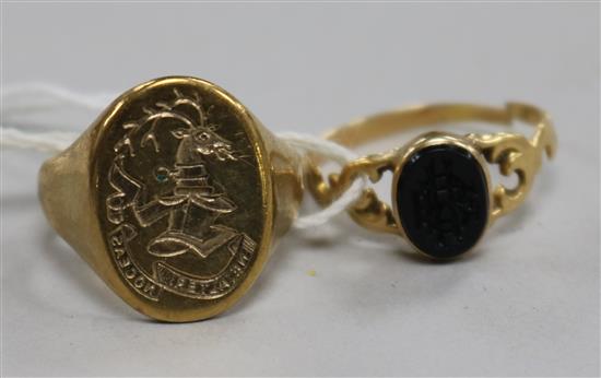 A 9ct gold signet ring with carved crested matrix and a 19th century yellow metal and black onyx ring.